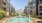 a swimming pool in a courtyard between buildings