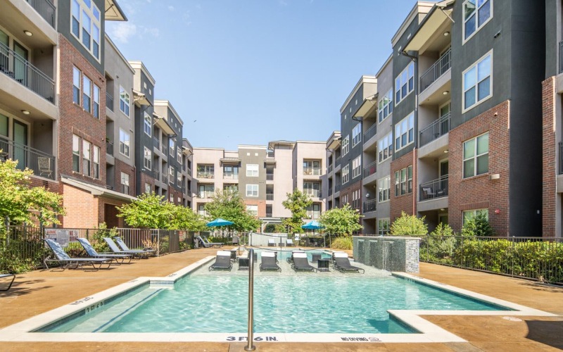 a swimming pool in a courtyard between buildings